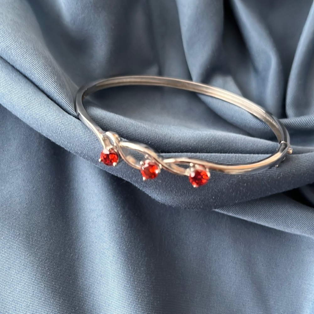 Sterling bangle bracelet with red stones.